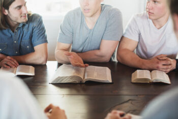 Men reading bibles at a men s group bible study 5760x3840
